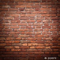 an old brick wall that is red and brown with some light coming from the top