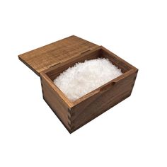 a wooden box filled with white rice on top of a white background and the lid is open