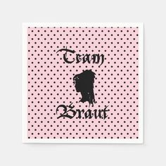 a pink and black polka dot paper napkin with the words team bratt on it