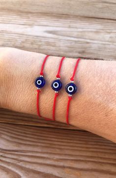 Red String Evil eye bracelet, good luck bracelet, gift for her or for him Very simple for everyday. A traditonal Greek gift for loved ones. Materials : ★ 8mm glass evil eye bead flat and round (size may vary from eye to eye) ★ 1mm nylon red cord (strong) ★ Stainless steel beads ★ Adjustable slip knot, you just have to pull the cords. Will fit most size. Available in 3 sizes : - Small       kid size / small wrist - Medium  - standard size - Large       - strong wrist Evil Eye Bracelet String, Evil Eye Beaded Bracelets As Gift, Traditional Evil Eye Bracelet For Gift, Symbolic Evil Eye Bracelet As Gift, Symbolic Evil Eye Beaded Bracelets For Gift, Handmade Red Evil Eye Bracelet As A Gift, Symbolic Evil Eye Beaded Bracelets Gift, Handmade Red Evil Eye Bracelet For Gift, Handmade Red Evil Eye Bracelet Gift