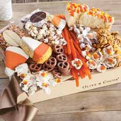 a box filled with lots of different types of candy and treats on top of a wooden table