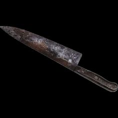 an old knife is shown against a black background