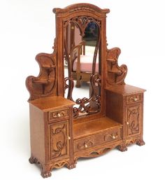 an antique wooden dressing table with mirror and drawers on it's sides, in front of a white background