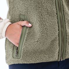 With the Stratus Vest, you might actually look forward to cloudy, chilly days. This eco-conscious layer offers warmth, style, and comfort all wrapped in a decadent 100% recycled polyester faux shearling fleece. While it may be love at first sight, the details of this vest will make you fall head over heels. This curly-piled fleece is matched with a mesh backer that serves two important functions: breathability and a smooth texture that makes sliding on over even the fluffiest sweaters a breeze. Casual Outerwear With Soft Texture And Cozy Fit, Casual Soft Winter Outerwear, Casual Snug Outerwear With Soft Texture, Casual Warm Snug Outerwear, Casual Green Recycled Polyester Outerwear, Snug Casual Outerwear With Fleece Lining, Casual Outerwear With Fleece Lining, Casual Snug Outerwear With Fleece Lining, Cold Morning