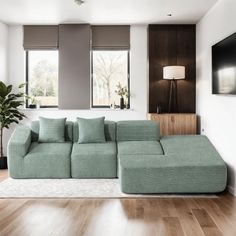 a living room with a large green couch