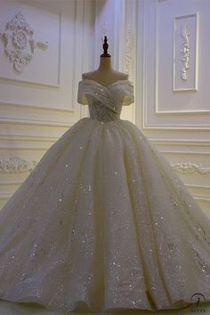 a ball gown is displayed on a mannequin in front of a white wall