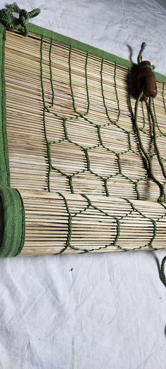 a close up of a bamboo mat on a white surface with green trimmings