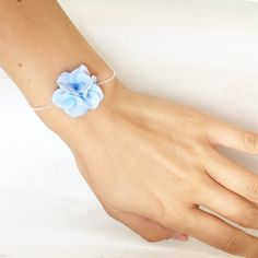 This blue hydrangea bracelet is fully handmade. Each element is made entirely by hands from material called cold porcelain and toned with soft pastel. These flowers look much like fresh flowers but they will never fade. I use only non-allergic nickel free bases for my items.Dimension of flower composition - about 1,2 inches * 1,2 inches (3 cm * 3 cm )This hydrangea bracelet is perfect for woodland, greenery or rustic weddings and other celebrations. But also they will be good even as casual acce Blue Flower Bracelet, Flower Composition, Rustic Weddings, Jewelry Blue, Bracelet Blue, Bridesmaid Bracelet, Blue Bridesmaids, Blue Hydrangea, Flower Bracelet