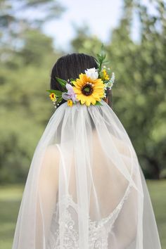 the back of a bride's veil with sunflowers on it