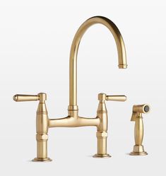 a golden faucet with two handles and nozzles on the side, in front of a white background