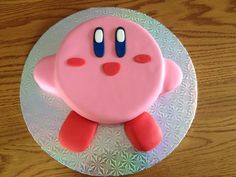 there is a cake that looks like a pink pacman on top of a plate