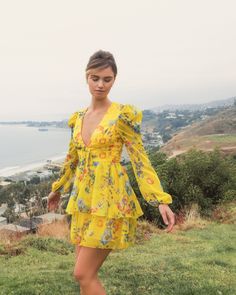 This charming mini dress features a deep v-neckline, long sleeves, and a ruffled tiered skirt. Ieena for Mac Duggal Printed mesh overlay fabric; 100% polyester lining Fully lined Deep v-neck Long sleeve No bust pads Concealed back zipper Approx. length from shoulder to hem: 33" Available in Yellow Multi Style #55838 Chic V-neck Tiered Party Dress, Chic Yellow Tiered Mini Dress, Spring V-neck Mini Dress With Ruffled Skirt, Spring V-neck Tiered Dress For Brunch, Yellow Tiered Mini Dress With Ruffles, Spring Tiered Long Sleeve Dress With Ruffles, Yellow V-neck Mini Dress With Ruffle Hem, Fitted Tiered Dress With Ruffle Hem And V-neck, Yellow Tiered Mini Dress For Brunch