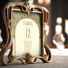 an ornate gold frame with a table number displayed in front of candles on a table