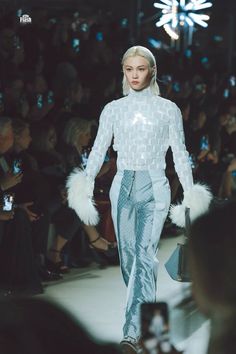 a model walks down the runway in white