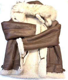 Kashani Men's Chocolate Brown Shearling Fox Hooded Bomber JacketMaterial: Shearling and FoxStyle: BomberColor: Chocolate Brown Winter Aviator Shearling Fur Coat, Hooded Shearling Outerwear With Faux Fur Lining, Shearling Aviator Fur Coat With Faux Fur Lining, Aviator Shearling Fur Coat With Faux Fur Lining, Luxury Aviator Winter Outerwear, Brown Hooded Leather Jacket With Faux Fur Lining, Brown Shearling Fur Coat With Fleece Lining, Winter Shearling Leather Jacket With Hood, Hooded Brown Sheepskin Fur Coat