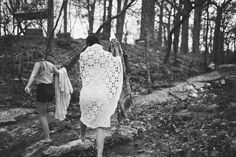 two women walking in the woods with scarves on