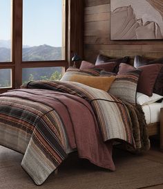 a bedroom with a large window overlooking the mountains