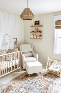 a baby's room with a crib, rocking chair, and rug in it