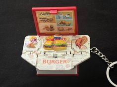 a burger box shaped keychain with a hamburger on it's front and sides