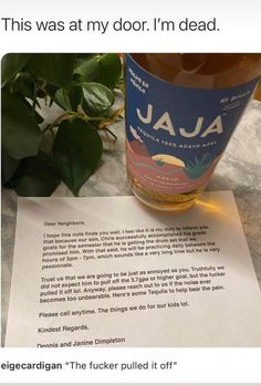 a bottle of jala on top of a table next to a piece of paper