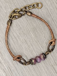 Czech Glass Purple Sapphire Blue Mix beads with antique brass accents on antique brown leather bracelet.  This bracelet has a size fit of approximately 7 inches to 7 1/2 inches. To keep beads, leather and all other components looking their best, avoid contact with water, lotions and perfumes. To access all other items in my shop, just hit the link here: https://www.etsy.com/ca/shop/KootenayLeatherRHS If you like jewelry, check out my other Etsy shop...it's jewelry for your door!  www.etsy.com/ca Adjustable Bohemian Bracelet With Antique Finish, Adjustable Bronze Bohemian Bracelets, Adjustable Antique Finish Jewelry Bracelet, Adjustable Antique Finish Bracelet, Handmade Adjustable Antique Bracelets, Antique Gold Adjustable Metal Bracelets, Adjustable Brown Metal Bracelets, Adjustable Brown Metal Bracelet, Brown Waxed Cord Jewelry For Everyday Use