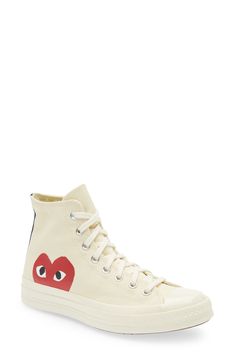 Cool vintage style elevates a street-ready sneaker stamped with a peekaboo heart. This collaboration between Comme des Garçons PLAY and Converse features classic Chucks styling with a playful, quirky twist—thanks to the imaginations of New York graphic artist Filip Pagowski and Comme des Garçon's own designer Rei Kawakubo. Removable insole Textile upper and lining/rubber sole Imported Asian Owned Canvas High-top Sneakers With Logo Print For Streetwear, Canvas High-top Lace-up Sneakers With Logo Print, Lace-up High-top Canvas Sneakers With Logo, Canvas Sneakers With Logo Print And Round Toe, Logo Print Canvas Sneakers With Round Toe, Casual High-top Sneakers With Logo-print Tongue, Casual High-top Sneakers With Logo-print Tongue And White Sole, Canvas High-top Sneakers With Logo Print, High-top Canvas Sneakers With Logo