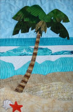 a quilted wall hanging with a palm tree and starfish on the beach,