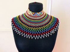 Add a touch of glam to your wardrobe with our handmade tuttleneck necklace in vibrant organic beads. Elegant Multicolor Necklace With Tiny Beads, Unique Tiny Beads Choker Necklace, Unique Colorful Beads Choker, Elegant Multicolor Round Beads Choker, Elegant Multicolor Beaded Choker, Unique Multicolor Beaded Choker, Unique Multicolor Choker Necklace, Elegant Multicolor Beaded Necklaces For Festivals, Elegant Multicolor Beaded Chain Choker