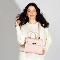 Feminine Pink Top Handle Bag -Chic & Versatile. Introducing our latest collection addition, Layla Bag in Pink. Lean into the femininity of a soft pink bag, perfect for spring and summer. This new-season Enjoy the versatility of Layla Bag with its adjustable strap, allowing you to wear it comfortably as a crossbody or shoulder bag, depending on your style preference. Bag Specifications Material: Vegan leather Interior: Luxurious suede lining Handles: Single handle, Removable shoulder strap Hardware: Golden-tone metal flap Pockets: One inner zipped pocket Closure: Front flap closure Size and Fit- Height: 20 cms / 7.9 In Handle Height: 10 cm / 3.9 In Width at bottom: 26 cm / 10.2 In Depth at bottom: 11 cm / 4.3 In Adjustable strap length: 55-60 cms / 21.7-23.6 ins Feminine Rectangular Bag For On-the-go, Spring Evening Shoulder Bag, Luxury Spring Bags For On-the-go, Pink Evening Satchel, Chic On-the-go Shoulder Box Bag, Feminine Evening Bag With Top Carry Handle, Elegant Spring Shoulder Evening Bag, Spring Evening Shoulder Bag With Detachable Strap, Spring Evening Satchel Shoulder Bag