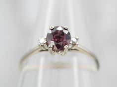 This elegant white gold engagement ring is perfect for any special occasion. It is encrusted with a sparkling pink sapphire and diamond accents, creating a beautiful, eye-catching display. With its timeless design, this ring makes a perfect symbol of love and commitment.Metal: 14K White GoldGem: Pink Sapphire .90 CaratsGem Measurements: 4.7 x 5.4 mm, OvalAccents: 2 Diamonds totaling .03 Carats, SI in Clarity, H in ColorRing Size: 6Marks: "14K" Stamped on the inside band Elegant Pink Sapphire Wedding Birthstone Ring, Wedding Rings With Brilliant Cut Pink Sapphire, White Gold Pink Sapphire Ring For Wedding, Pink Platinum Wedding Rings, Pink Platinum Ruby Ring For Wedding, White Gold Pink Sapphire Diamond Wedding Ring, Wedding Pink Sapphire Diamond Ring With Vvs Clarity, Wedding Pink Sapphire Ring With Center Stone, Wedding Pink Sapphire Diamond Ring In White Gold