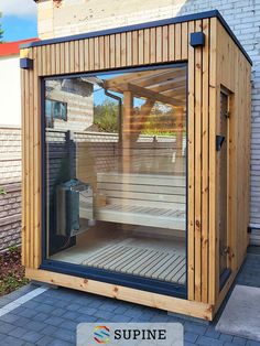 a wooden sauna with glass doors on the outside