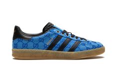 The Gucci x adidas Gazelle “Blue” is a limited edition collaboration between the legacy fashion brand and adidas on the retro shoe with Gucci’s iconic monogram print on its design.  Marking the second-ever collaboration between Gucci and adidas, the Gazelle in “Blue” updates the old school shoe with Gucci’s famous “GG” monogram patterning in an all-over style that draws favorably from 1980s-era sportswear.  Black leather Three Stripes branding can be found on either side of the shoe while gold co-branding appears on the black leather heel tab.  More co-branding is located on the tongue.  “GG” embossed branding is found along the gum rubber midsole.  Release date: March 31, 2023 Adidas Shoes Gazelle, Adidas Gazelle Blue, Adidas X Gucci, Gucci X Adidas, Stripes Branding, Hippie Shoes, School Shoe, Gucci Brand, Gg Monogram