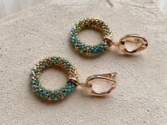 two pairs of gold and turquoise beaded hoop earrings