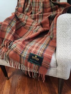 a plaid blanket sitting on top of a chair