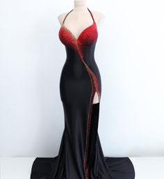 The daring combination of black satin, scarlet, and gold rhinestones creates a striking allure. The dress features an impeccable contour that elegantly embraces the figure, while its carefully curated design adds an air of refinement. This striking gown is a true embodiment of glamour and allure, guaranteed to leave a lasting impression. Production time excluding delivery: finished design - 4-5 weeks; custom design 2-3 months. ----------------------------------------------------- We invite you t Gold Gown With Fitted Bodice For Night Out, Red Satin Embellished Evening Dress, Black Satin Party Gown, Fitted Satin Evening Dress For Red Carpet, Red Embellished Satin Evening Dress, Black Satin Gown For Party, Evening Dress With Rhinestones And Fitted Bodice, Red Fitted Bodice Gown For Night Out, Red Gown With Fitted Bodice For Night Out