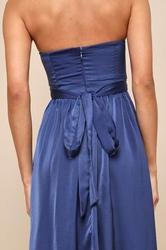 You'll look fabulous in an instant with a effortlessly sleek look like the Lulus Lavish Elegance Navy Blue Satin Strapless Bubble-Hem Midi Dress! Luxe stretchy satin shapes this lovely dress that has a strapless, princess-seamed bodice (with hidden no-slip strips and supportive side boning) and a straight neckline. A high, banded waist features long tying sashes that secure at the back, all atop a flowy, A-line skirt that cascades down to a chic midi, bubble-style hem. Hidden back zipper/clasp. Strapless Satin Bridesmaid Dress For Formal Occasions, Blue Strapless Midi Dress For Prom, Strapless Summer Evening Bridesmaid Dress, Strapless Bridesmaid Dress For Summer Evening, Blue Bridesmaid Dress With Sweetheart Neckline For Evening, Blue Bandeau Evening Dress, Elegant Floor-length Strapless Dress For Bridesmaids, Elegant Blue Bandeau Strapless Dress, Elegant Floor-length Strapless Bridesmaid Dress