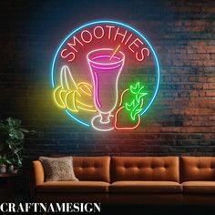 a neon sign that says smoothies on the wall next to a couch and table