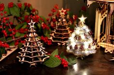 small christmas trees and decorations on a table