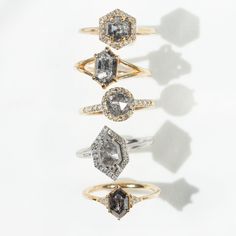 three different types of engagement rings on a white surface with shadows from the top and bottom