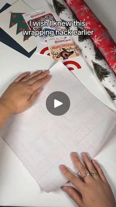 someone is making a christmas card with wrapping paper