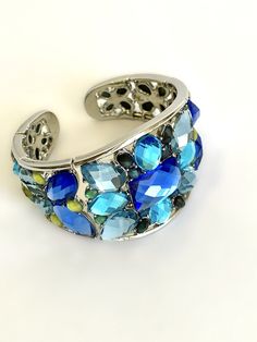 "Dressed Up or Down, This Cuff will Take You There in Shimmering Style Faceted Stones In Shades of Blue Envelops The Wrist In Glorious Sparkling Color Contour Designed to Fit The Wrist with a Genius Flexible Construction That Allows For Easy On- Off Super Cool Paired With Jeans and a Tee Shirt, Pretty With Summer Dresses, Stylish In The Evening, Sophisticated and Chic Over the Sleeve of a Black Sweater in the Cooler Months Would Pair Beautifully with many items in my shop, Including the Items Pr Blue Bracelet Strap Jewelry, Adjustable Blue Cuff Bracelet For Party, Blue Jewelry With Bracelet Strap, Blue Metal Beaded Bangle Bracelet, Adjustable Blue Metal Bracelets, Adjustable Blue Metal Bracelet, Blue Bangle Cuff Bracelet For Party, Light Blue Bracelet For Party, Blue Cuff Bracelet Gift