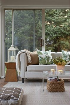 a living room filled with furniture and lots of windows