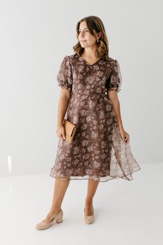 Introducing the 'Fawn', the midi dress with a perfect blend of ethereal beauty and elegance. Created with a delicate organza fabric and adorned with stunning florals, this dress promises to steal the show at any occasion. Whether you're attending a summer wedding or a romantic dinner date, its lightweight fabric and sophisticated design will carry an effortless grace. Self & Lining 100% Polyester Hand Wash Cold Do Not Bleach Hang to Dry Fully Lined Model Height 5'6" | Wearing Size Small Please carefully measure a similar item before placing your order to allow for the best fit and also to reduce the risk of returns. Have questions about fit? Call us! We try everything on, so we know how our clothes fit and we’re happy to assist you. Customer Service: 717.598.8309 9 AM - 3 PM EST All conver Feminine Organza Dress For Garden Party, Spring Formal Organza Dresses, Fitted V-neck Organza Dress, Formal Organza Dresses For Spring, Spring Floral Print Organza Dress, Floral Print Chiffon Midi Dress, Elegant Spring Floral Print Chiffon Dress, Sheer Organza Dress With Short Sleeves, Sheer Organza Short Sleeve Dress