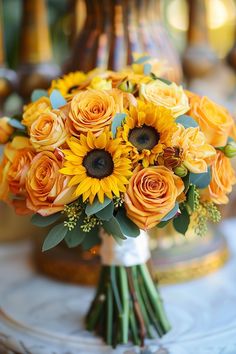 a bouquet of sunflowers and roses on a table