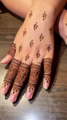 hendi tattoos on the hands of a woman