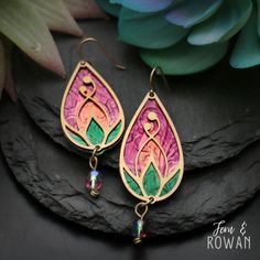 These Handmade Lotus Flower Bud Earrings are a beautiful gift for for anyone who is enchanted with the beautiful lotus flower!  These earrings feature a Colorful Lotus Flower that has been careful handmade and painted in our studio. The Lotus Flower symbol has used in many ancient cultures to represent spiritual awakening. Today it is seen as a sign of strength, resilience, and enlightenment.  These beautiful earrings have an eye-catching appearance that would look great with any outfit! These S Mother's Day Nickel Free Dangle Flower Earrings, Mother's Day Nickel-free Dangle Flower Earrings, Artistic Dangle Flower Earrings As Gift, Pink Teardrop Beads For Jewelry Crafting, Artistic Dangle Flower Earrings For Gifts, Pink Teardrop Jewelry Beads For Crafting, Whimsical Multicolor Flower Charm Earrings, Teardrop Pink Jewelry For Crafting, Pink Teardrop Flower Earrings With Ear Wire