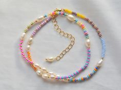 Beaded necklace for women. In bright colors and highlighted with freshwater pearls. Perfect for everyday use and summertime. The gold colored beads have a permanent finish and won't tarnish. The chain and clasp are 24k gold plated brass. Each jewelry item comes in a colorful envelope, as seen in the last picture, and is ready to be gifted. You can find more necklaces on this link https://www.etsy.com/shop/GirassolBeads?section_id=33629856 Designed and created in Berlin at GirassolBeads. PERSONAL Best Friend Beaded Necklace, Beaded Jewelry Colorful, Cute Colorful Jewelry, Beaded Best Friend Bracelets, Colorful Beaded Jewelry, Elegant Colorful Beaded Necklace, Beaded Necklaces Ideas, Cute Beaded Necklaces, Beaded Bracelet Designs