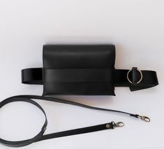 Handmade with genuine leather belt bag in black is here! Black is classy and timeless choice for any season, a black bag is must have in our wardrobe. The new design we have made comes with two straps, so you can wear your new leather bag in two ways, both as a belt bag and a crossbody bag as you wish! UltimaEra *handmade design is a startup business created by women for women, supporting sustainable fashion, you will never miss your new favorite genuine leather bag, and individual unique style of each of us! We are based in Athens - Greece - and every product in our brand is ethical made, designed, handcrafted and produced exclusively by us... So be kind to be patient if sometimes shipping take a little bit longer. Black Office Bag With Leather Strap, Black Rectangular Belt Bag For Office, Black Leather Bag Strap For On-the-go, Chic Black Belt Bag For Business, Black Belt Bag With Belt Included For Travel, Black Belt Bag For Travel With Belt Included, Black Belt Bag With Removable Pouch For Office, Leather Bag Strap For On-the-go In Black, Black Leather Belt Bag With Removable Pouch