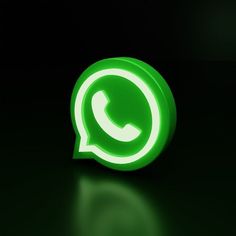 a green whatsapp button on a black background