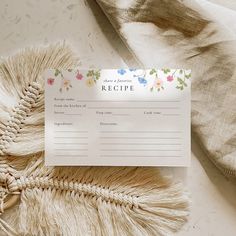 a recipe card sitting on top of a table next to a blanket and pillow,